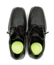 Tennis balls in shoes Royalty Free Stock Photo