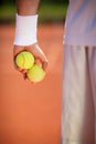 Tennis balls in tennis player`s hand, close up Royalty Free Stock Photo