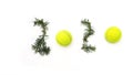 Tennis Christmas and 2020 New Year concept with tennis balls and fir branches with numbers on white snow, isolated. Royalty Free Stock Photo