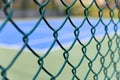 a tennis court behine wire fence horizontal composition Royalty Free Stock Photo