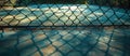 Tennis Court Viewed Through Chain Link Fence Royalty Free Stock Photo