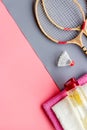 Tennis equipment - rockets, shuttlecock - on pink ang grey background top-down frame copy space Royalty Free Stock Photo