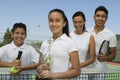 Tennis Family on court by net daughter holding trophy portrait Royalty Free Stock Photo