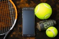 Tennis gear Racket, balls, and a mobile phone, ready for a match Royalty Free Stock Photo
