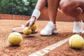 Tennis is her life. Cropped closeup of sporty female legs on tennis court. Beautiful woman tennis player picks up tennis ball off Royalty Free Stock Photo