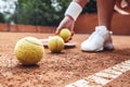 Tennis is her life. Cropped closeup of sporty female legs on tennis court. Beautiful woman tennis player picks up tennis ball off Royalty Free Stock Photo