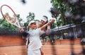Tennis instructor with young girl on tennis training. Cropped image of a female tennis instructor teaching girl to serve child on Royalty Free Stock Photo