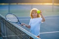 Tennis kids. Child playing tennis. Sport child with racket on tennis playground during training in summer.