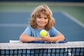 Tennis kids. Tennis is my favorite play. Portrait of a pretty sporty child with a tennis racket. Little kid smiling