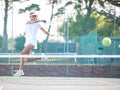 Tennis, outdoor match and woman hit a sports ball with a racket service on a exercise court. Sport game, workout Royalty Free Stock Photo