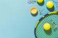 Yellow tennis ball and racket on a blue background of hard tennis court Royalty Free Stock Photo