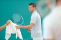 Tennis player being passed towel Royalty Free Stock Photo