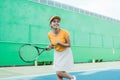 tennis player with clenched hand gesture after hitting ball score