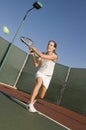 Tennis Player Hitting Backhand on tennis court Royalty Free Stock Photo