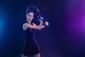 Tennis player with racket on tournament. Girl athlete with tenis racket on court with neon colors. Sport concept