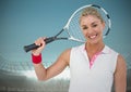 Tennis player smiling against stadium with blue sky and bright lights Royalty Free Stock Photo