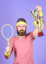 Tennis player win championship. Athlete hold tennis racket and golden goblet. Man bearded hipster wear sport outfit Royalty Free Stock Photo