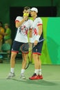 Tennis players Andy Murray R and Jamie Murray of Great Britain in action during men`s doubles first round match of the Rio 2016 Royalty Free Stock Photo