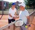 tennis players of different generations shake hands before tennis match Royalty Free Stock Photo