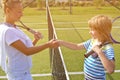 Tennis players shake hands before and after the tennis match. In the photo it looks like shaking hands greeting each other closely Royalty Free Stock Photo