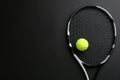 Tennis racket and ball on black background, top view. Space for text Royalty Free Stock Photo