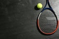 Tennis racket and ball on black table, flat lay. Space for text Royalty Free Stock Photo