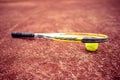 Tennis racket and ball on clay tennis court Royalty Free Stock Photo