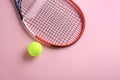 Tennis racket and ball on pink background, flat lay. Space for text Royalty Free Stock Photo