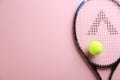 Tennis racket and ball on pink background, top view. Space for text Royalty Free Stock Photo