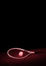 Tennis racket with tennis balls on grass with black background and copy space. Red filter Royalty Free Stock Photo