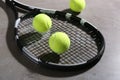 Tennis racket and balls on grey table. Sports equipment