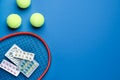 Tennis racket, balls and pills on blue background, flat lay with space for text. Doping concept Royalty Free Stock Photo