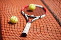 Tennis racket and balls on red clay