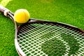 Tennis racket on green background close up