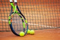 Tennis rackets and balls leaned against the net Royalty Free Stock Photo