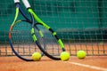 Tennis rackets and balls leaned against the net Royalty Free Stock Photo