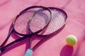 tennis rackets and tennis balls lying on pink tennis court. ai generated Royalty Free Stock Photo