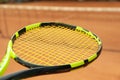 Tennis racquet against clay court close up Royalty Free Stock Photo