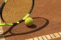 Tennis racquet and tennis ball on clay court Royalty Free Stock Photo
