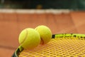 Tennis racquet tennis balls against clay court Royalty Free Stock Photo