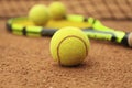 Tennis racquet tennis balls on clay court Royalty Free Stock Photo
