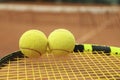 Tennis racquet tennis balls against clay court Royalty Free Stock Photo