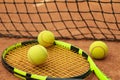 Tennis racquet with tennis balls clay court Royalty Free Stock Photo
