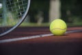 Tennis racquet and yellow tennis ball near white line Royalty Free Stock Photo