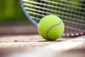 Tennis racquet and yellow tennis ball on outdoor court Royalty Free Stock Photo