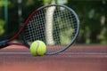 Tennis racquet and yellow tennis ball on outdoor court Royalty Free Stock Photo