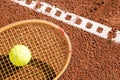 Tennis raquet with tennis ball on ash court Royalty Free Stock Photo