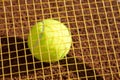 Tennis raquet with tennis ball on ash court Royalty Free Stock Photo