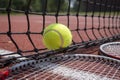 Tennis scene with black net, ball and racquets Royalty Free Stock Photo