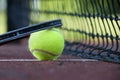 Yellow tennis ball near white line and black net Royalty Free Stock Photo